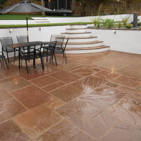 autumn brown Indian sandstone paving wet